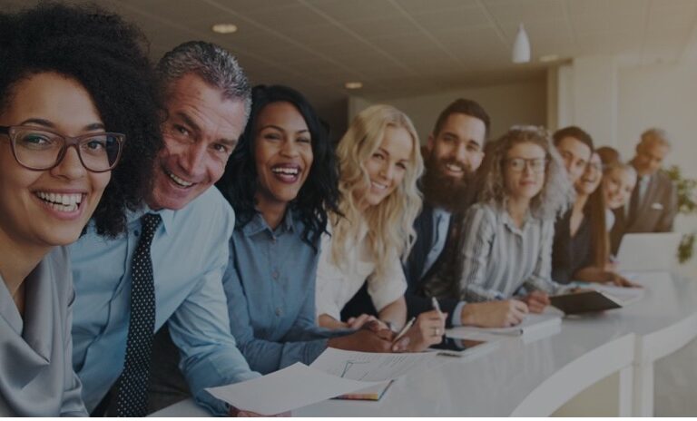 Photo of colleagues from different cultures smiling at the camera